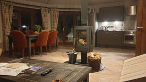 The open plan kitchen and living room with a central woodburner