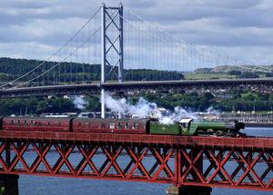 The Flying Scotsman passes over the Forth Bridge near Edinburgh in Scotland. The most famous steam locomotive in the world is celebrating her centenary year, having entered service on 24 February 1923.