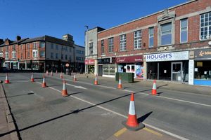 The cones are visible on both sides, leaving one lane of traffic