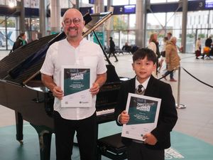 Supporting image for story: Boy, 10, and aid worker triumph in piano contest at Grand Central Station