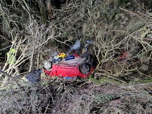 A driver was rescued from their car after becoming trapped in fast-rising water following a road traffic collision near Talgarth
