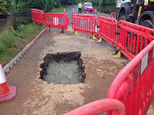 Supporting image for story: Road closed by water mains burst collapse