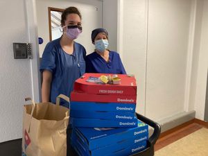 Hospital staff receive the pizzas