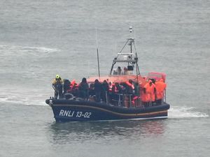 The Dungeness Lifeboat brings a group of people into Dover.