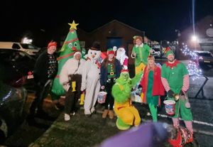 Santa and friends lighting up the night — one doorstep at a time.