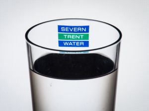 The logo of water company Severn Trent Water seen through a glass of water