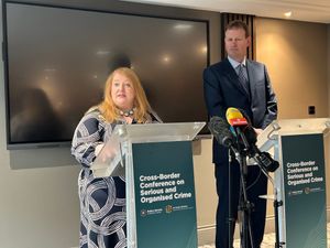 Naomi Long and Jim O'Callaghan at a conference in Belfast on Monday