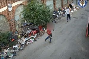 Haiwa Ezzeddine Mohammed runs away chased by the man with the wood