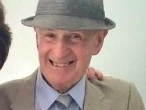 John Mackey wearing a trilby and smiling
