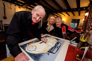 Norman Dewis autograph's Karen Kay's painting or Rob Keymer's Jaguar E-Type