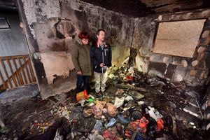 The couple in their old home, wrecked by fire