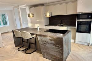 Sleek open-plan kitchen and dining space, finished to a high modern standard