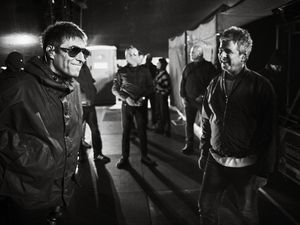 Supporting image for story: Liam and Noel Gallagher shown having a laugh in Oasis tour photography book