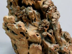 The rocky outcrop is populated by sages and figures walking up a precarious path through gnarled pine trees and caves.