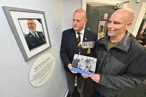 Andy (left) and Chris Turley inside the Christopher Turley Armed Forces Community Hub where there is a picture of their father 