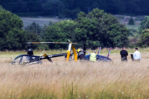Emergency services at the scene after a helicopter rolled onto its side. Photo: SnapperSK
