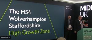 Councillor Mark Winnington on stage at the business event