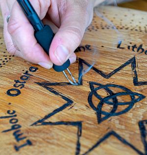 Stef burns her design onto the wood