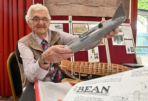 Derek Nicholls with his Bean car/ transport display. He is pictured with a model of the Thunderbolt Car, built by Bean and once held the land speed record, and a model of a Zeppelin that killed a number of people in Tipton during the war.