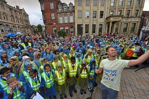 Supporting image for story: Wolverhampton school pupils singing in the rain in Queens Square