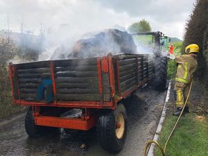 Supporting image for story: Road shut as giant straw bales caught in tractor fire