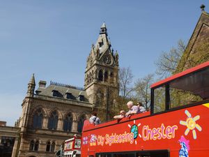 A sightseeing tour bus outside Chester town hall