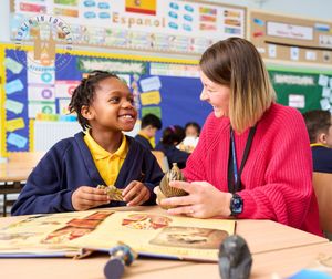 Staff member at Hanley St Luke's, part of Three Spires Trust, working with a child.