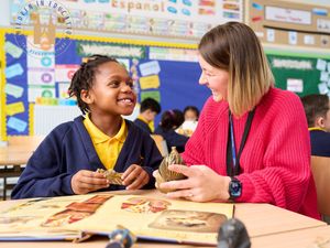 Staff member at Hanley St Luke's, part of Three Spires Trust, working with a child.
