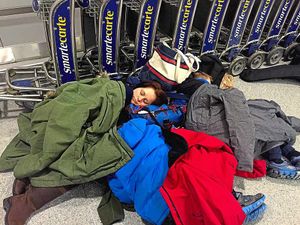 The family sleep in the departure lounge