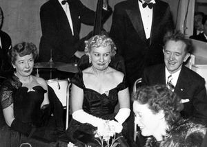 Stan Laurel at an unidentified reception in Shrewsbury in April 1952, with his blonde wife – who became a crime victim – and, left, Oliver Hardy's wife.