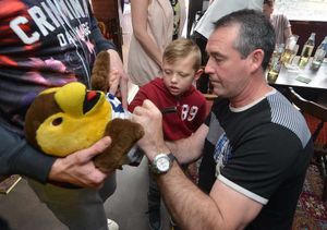 Five-year-old fan, Harrison Albert, gets Bob Taylor's autograph