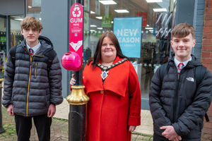 Marches School pupils Seth (left) and Cian with Oswestry mayor Rosie Radford and one of the new chewing gum bins. Photo: Grum