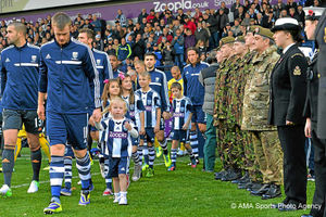 Albion players walk past the Poppy Day guard of honour as they make their way onto the pitch