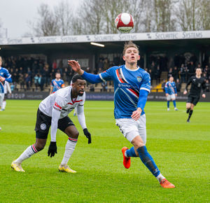 Joel Taylor watches Jake Charles win the header.