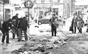Workers clear the pavement of snow in Dudley Street, Wolverhampton