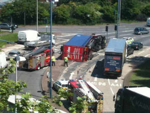 Supporting image for story: Chaos as lorry topples over