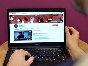 The home page of YouTube displayed on a laptop computer