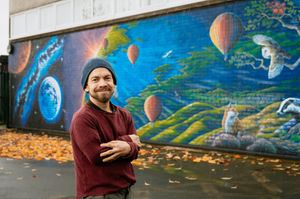 Rory McCann with his latest mural created in Church Stretton