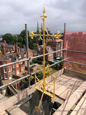 The cross is restored to to the roof of the cathedral
