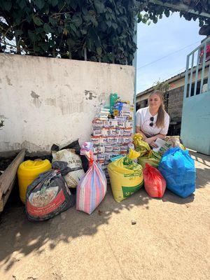 Lottie's Way Trustee Sophie Goodwin with the donation from Lottie's Way and GLW Feeds at Loving Hands Orphanage in Gilgil.