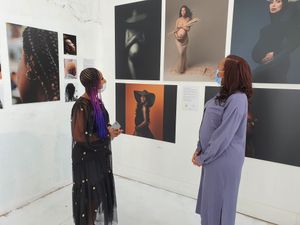 Denise Maxwell and Janella Binns take in some of the pieces in the exhibition