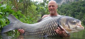 Hodgkinson holds a 100lb Siamese carp 