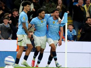 Matheus Nunes, right, celebrates with Nico O'Reilly, left, and Omar Marmoush after scoring Manchester City's late winner