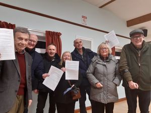 Housing plan opponents in Church Aston hold up their campaign crib sheets. On the left is councillor Andrew Eade and on the right Simon Stacey, chairman of Church Aston Parish Council Picture: LDRS