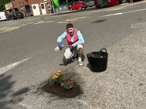 Supporting image for story: 'I'm on a mission to highlight the West Midlands pothole problems by making them look pretty by planting bright flowers'