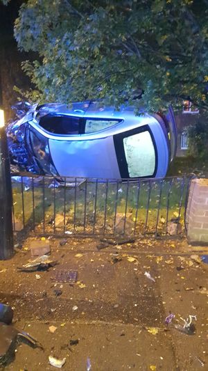 A car overturned and ended up in the font garden of a house. Photo: West Midlands Fire Service