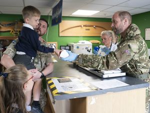 Supporting image for story: William in accommodation pledge as he dishes out bacon rolls to soldiers