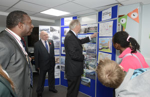 HRH The Duke of Gloucester looks at photographs and artwork produced by children as he visits The Hope Community Project