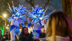 Christmas stilt walkers on campus