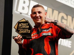Nathan Aspinall celebrates with the trophy after winning Night 15 of the Premier League in Aberdeen